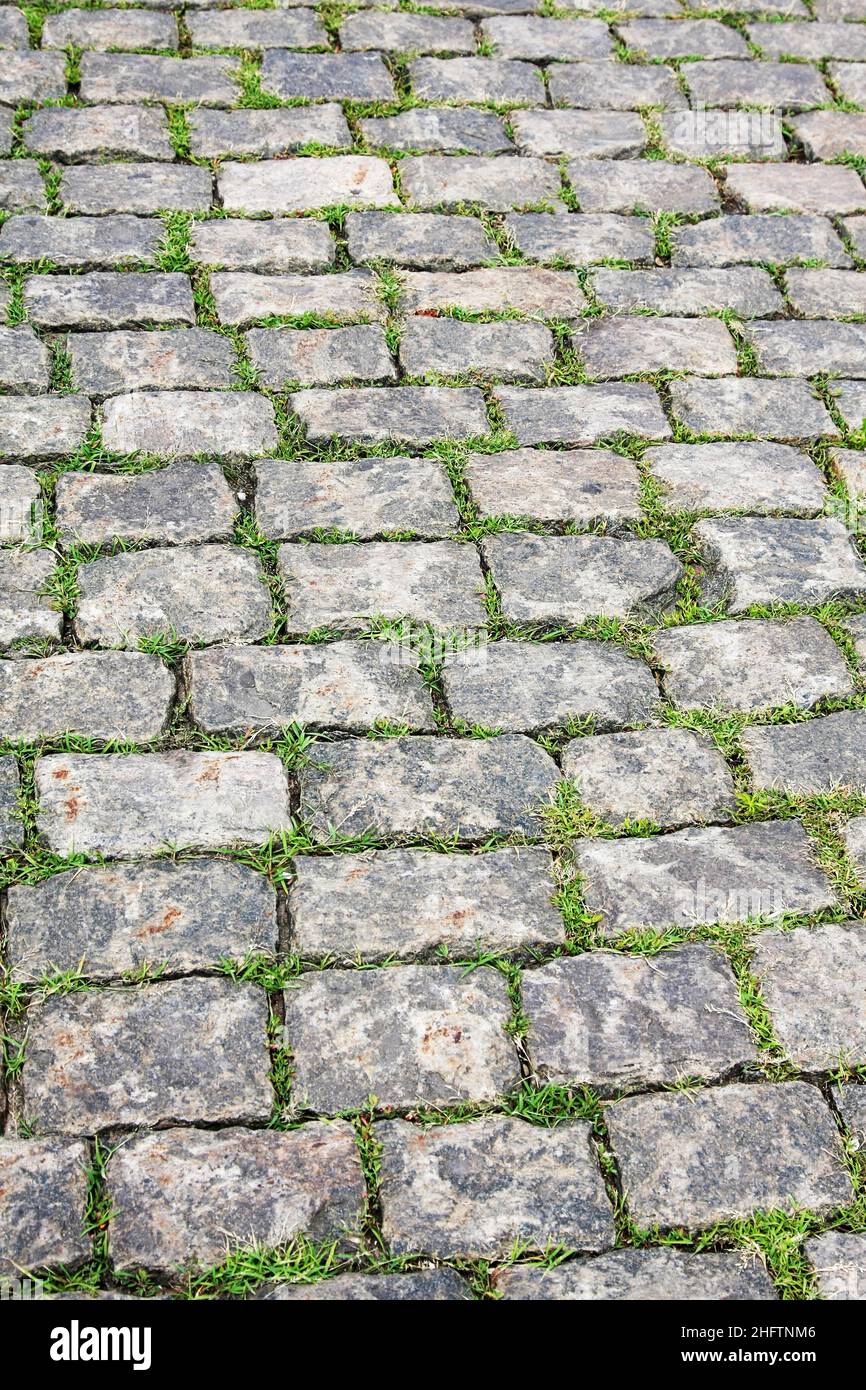 Stone pavement with green grass. Texture or background Stock Photo - Alamy