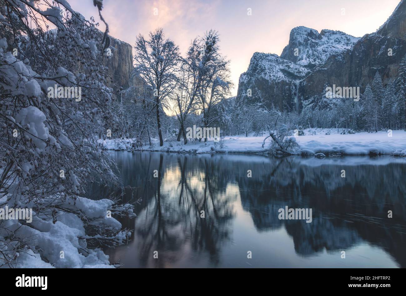 Bridalveil Falls at the Cathedral Rocks and their reflections on the Merced River on a winter morning, Yosemite National Park, California, USA. Stock Photo
