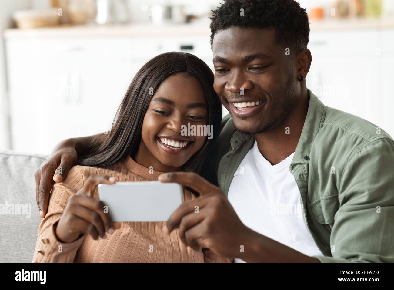 Happy african american lovers taking selfie on cellphone Stock Photo