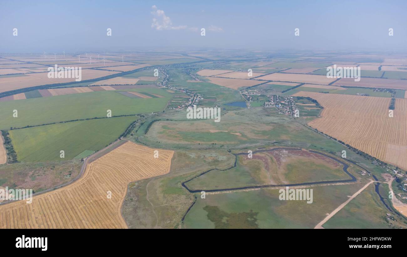 Wheat field in summer by the sea after harvest. Aerial view. Stock Photo