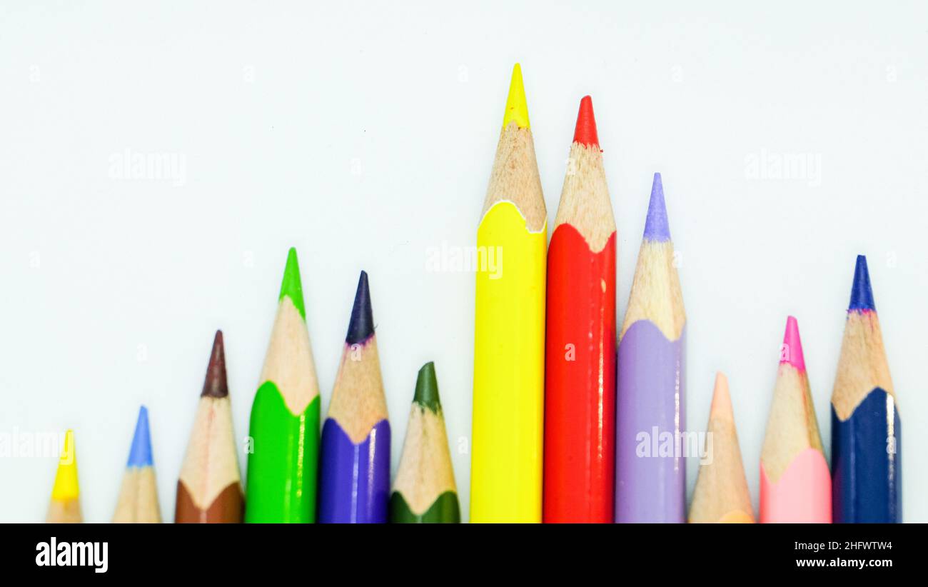Color pencils arranged to form a rainbow on white background. Isolated