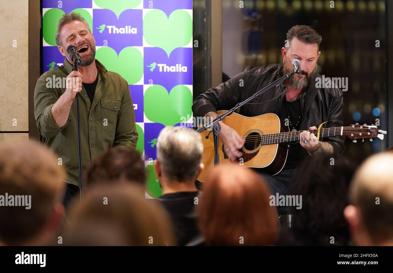 Hamburg, Germany. 17th Jan, 2022. Singer and musician Sasha (l) sings alongside guitarist Chris Vega during the musical reading of his first book 'If You Believe - The Autobiography' at the Thalia bookstore in the Europa Passage. Credit: Marcus Brandt/dpa/Alamy Live News Stock Photo