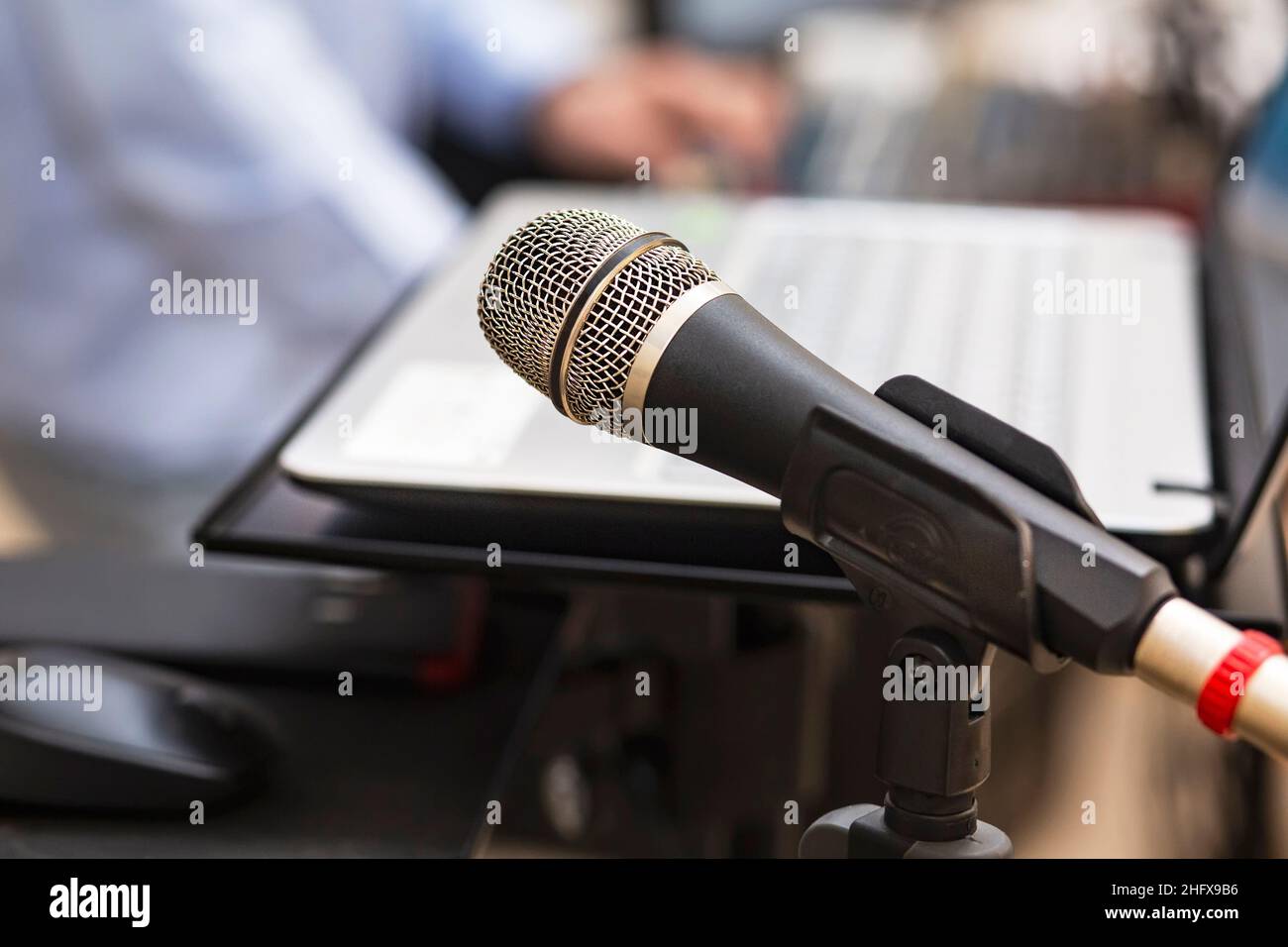 Studio microphone near computer and DJ mixing console to create music and songs in the studio. Microphone and studio equipment for DJ performance at a Stock Photo
