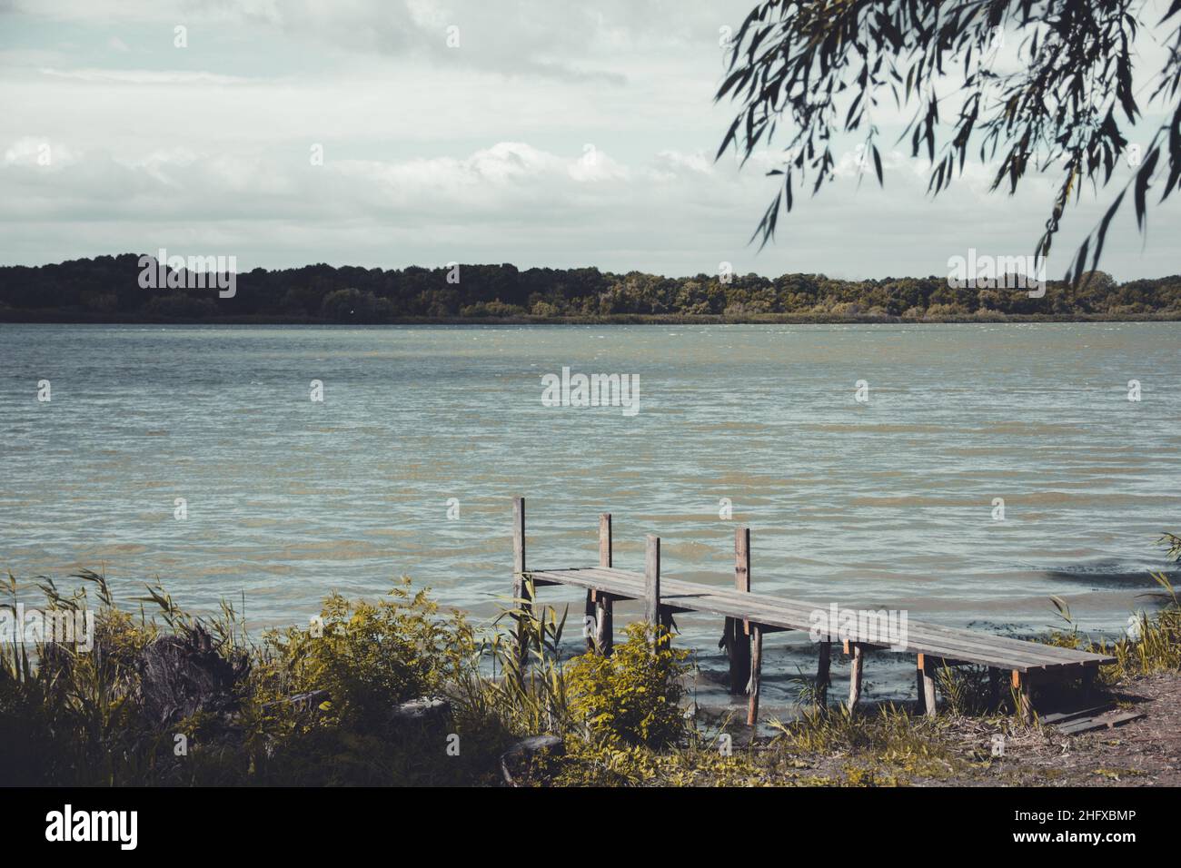 Beautiful wooden pier near the river bank Stock Photo - Alamy