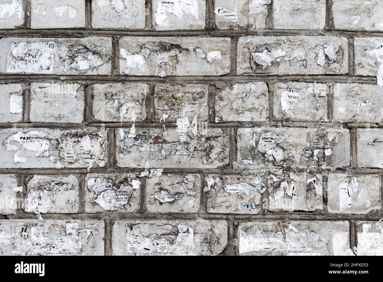 Abstract background old white brick wall with cracks and scratches ...