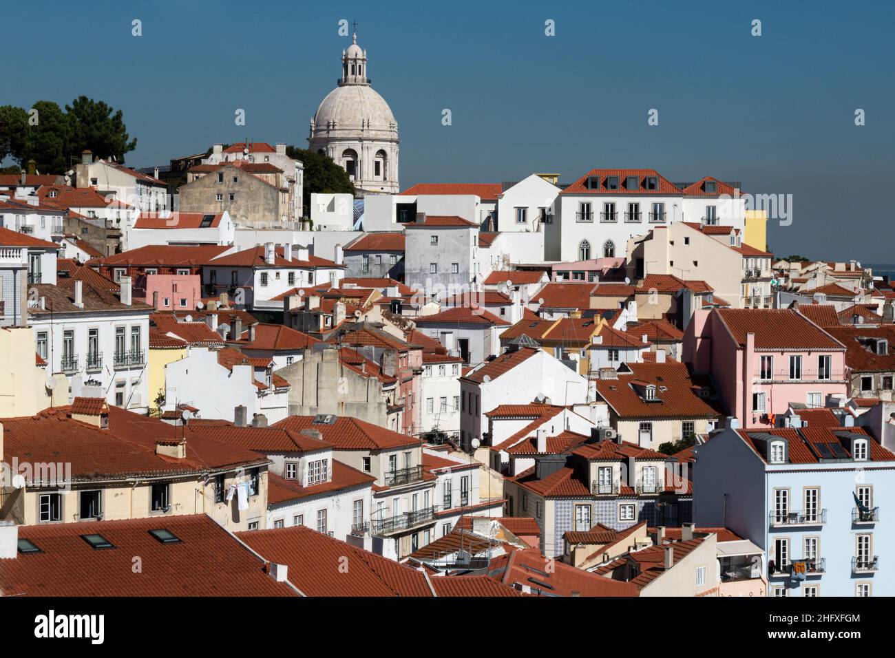 View from Miradouro do Sol across the rooftops of the Alfama neighbourhood and the National Panteon (Panteão Nacional) in Lisbon Portugal Stock Photo