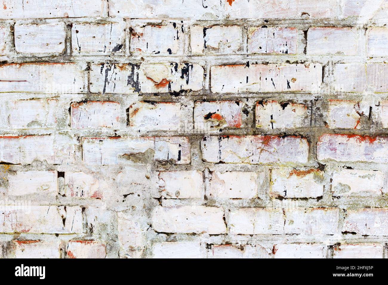 Abstract background old white brick wall with cracks and scratches ...