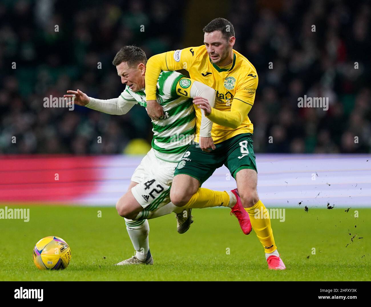 Celtic's Callum McGregor (left) and Hibernian's Drey Wright battle for the ball during the cinch Premiership match at Celtic Park, Glasgow. Picture date: Monday January 17, 2022. Stock Photo
