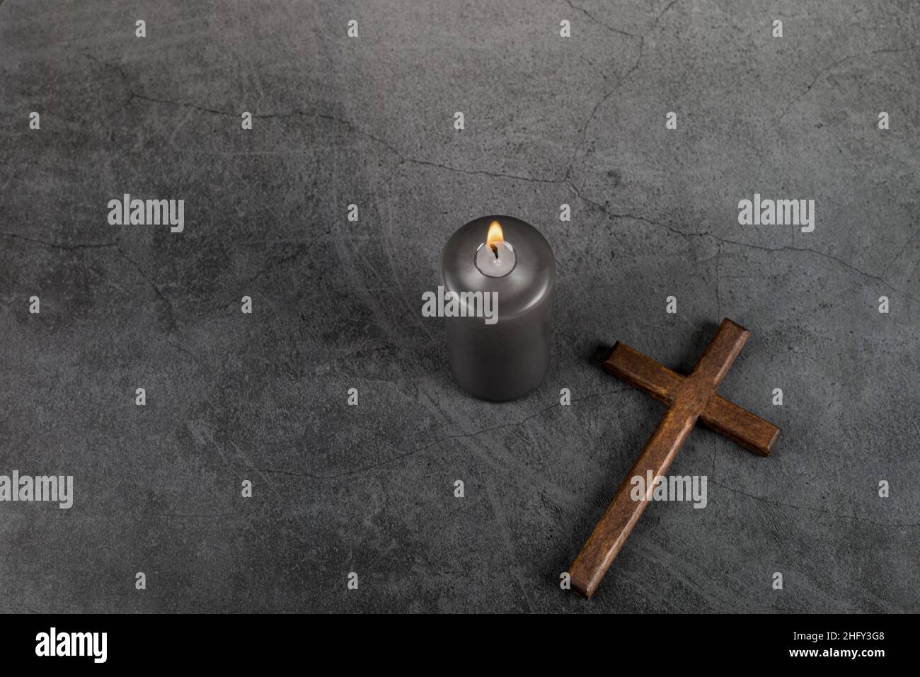 Catholic Cross with burning candle. Ash Wednesday, Lent season, Holy