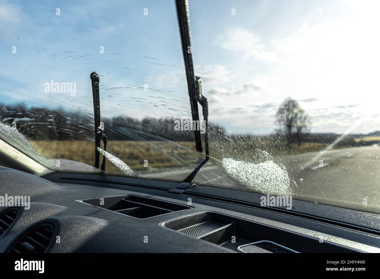 Car wipers clean windshields when driving in sunny weather Stock Photo Alamy