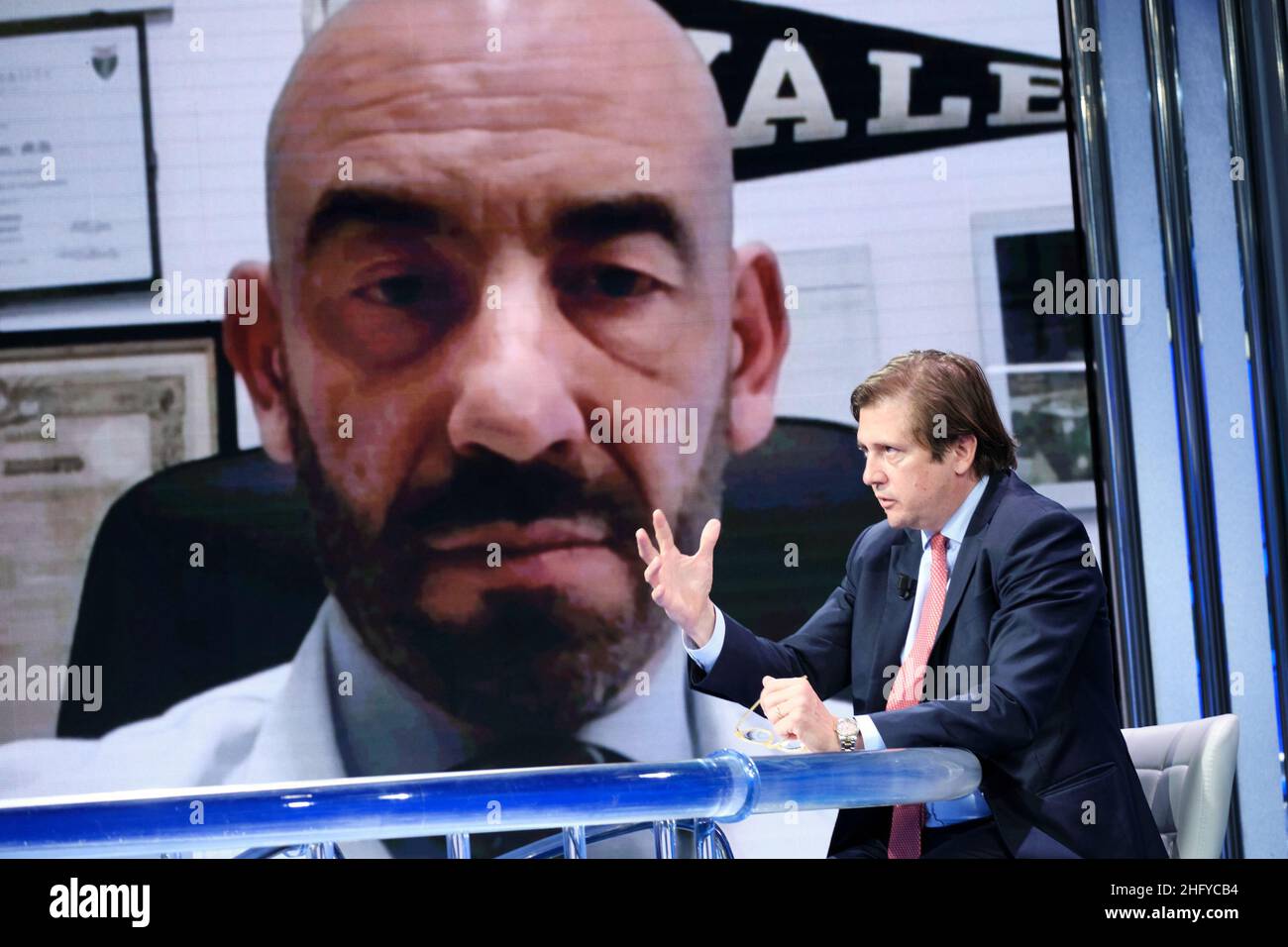 Mauro Scrobogna /LaPresse May 20, 2021 Rome, Italy Politics RAI - 'Porta a Porta' broadcast In the photo: Undersecretary of health Pierpaolo Sileri, on screen and the infectious disease specialist Matteo Bassetti Stock Photo