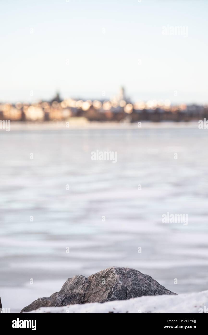 Helsinki / Finland - JANUARY 13, 2022: Out of focus silhouette of downtown Helsinki across the river. Stock Photo