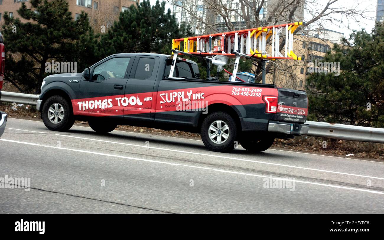 Truck delivering tools building work site pickup ladders street road hires stock photography