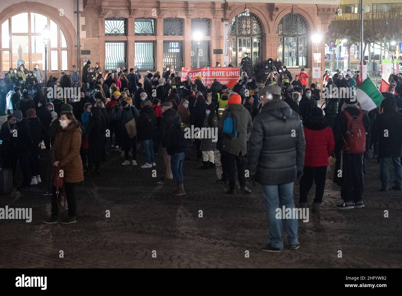17 January 2022, Hessen, Frankfurt/Main: Demonstranten stehen während einer Demonstration gegen die Corona-Maßnahmen mit einem Banner, auf dem 'Wir sind die rote Linie' steht, auf dem Römer. Photo: Sebastian Gollnow/dpa Stock Photo