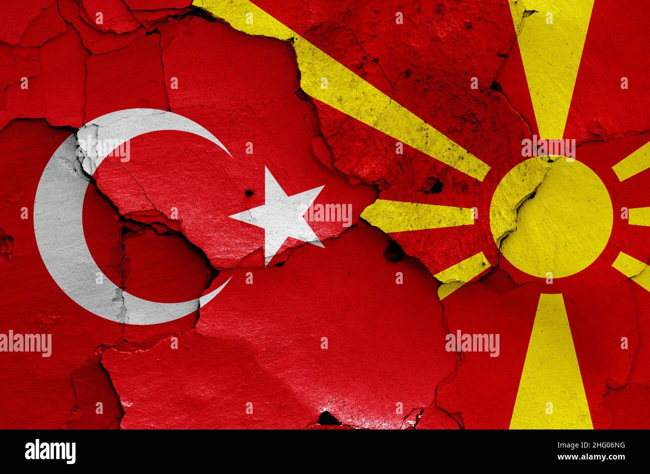flags of Turkey and North Macedonia painted on cracked wall Stock Photo