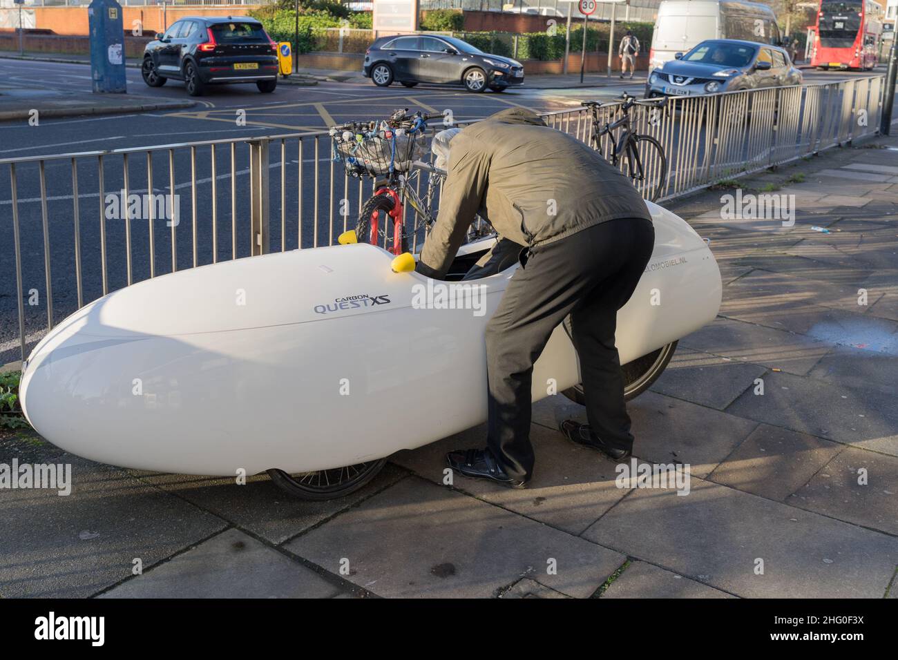 man attends to Quest XS Velomobiel , commuting vehicle , at London ...