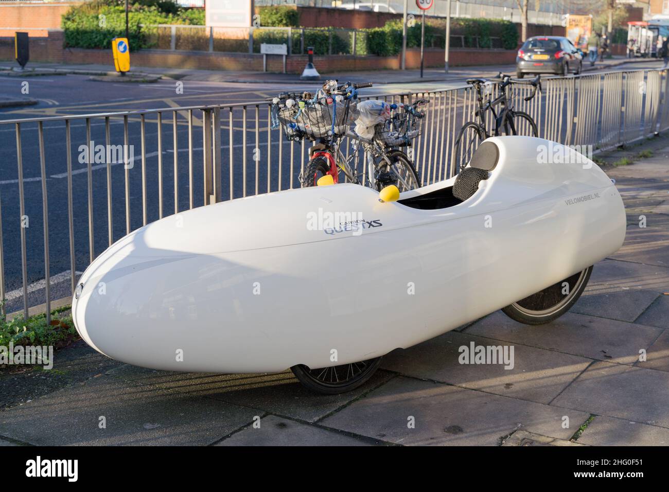 Quest XS Velomobiel , commuting vehicle parks next to bike, bicycles ...