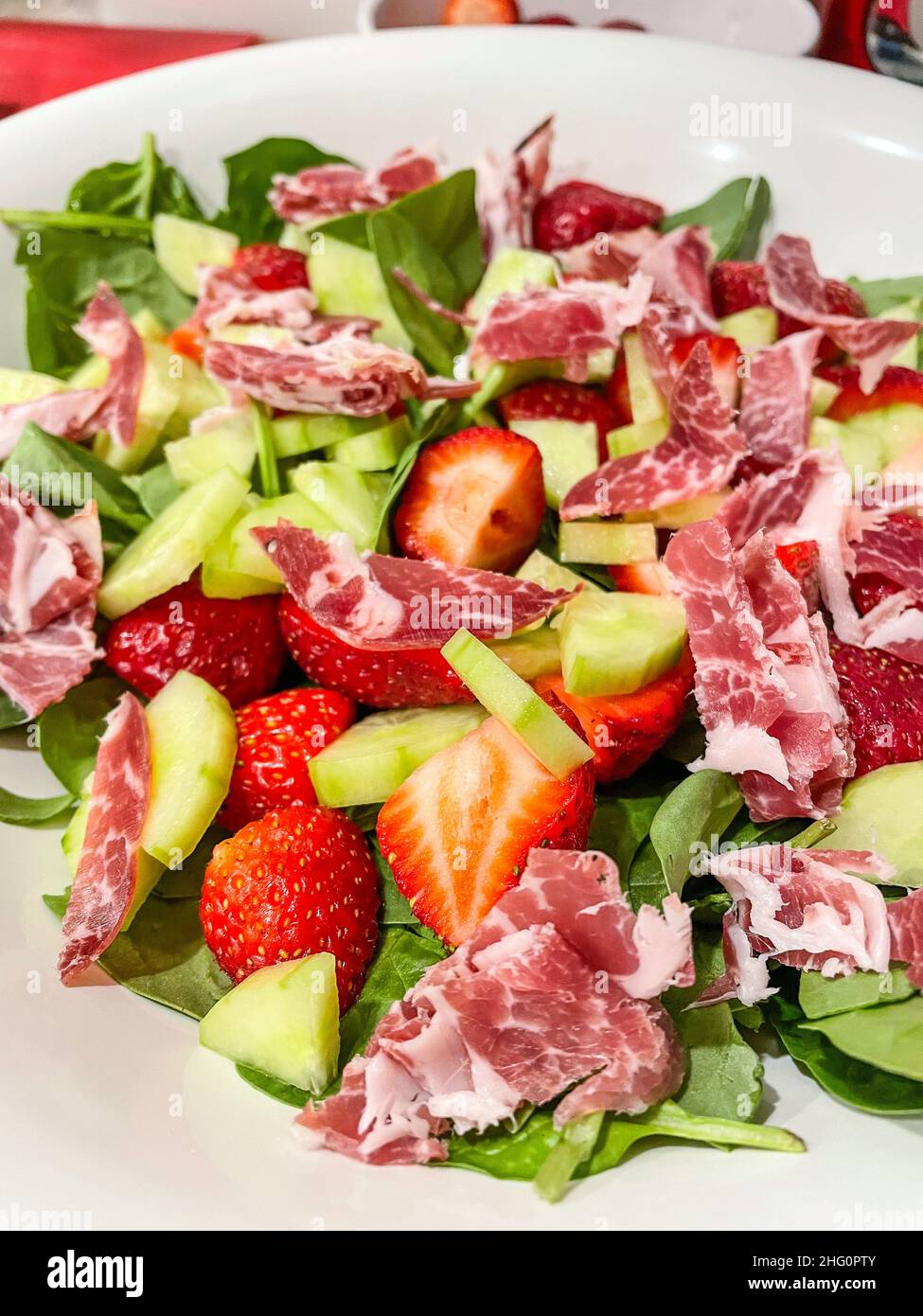 Strawberry spinach salad with bacon with simple dressing is made by combining olive oil