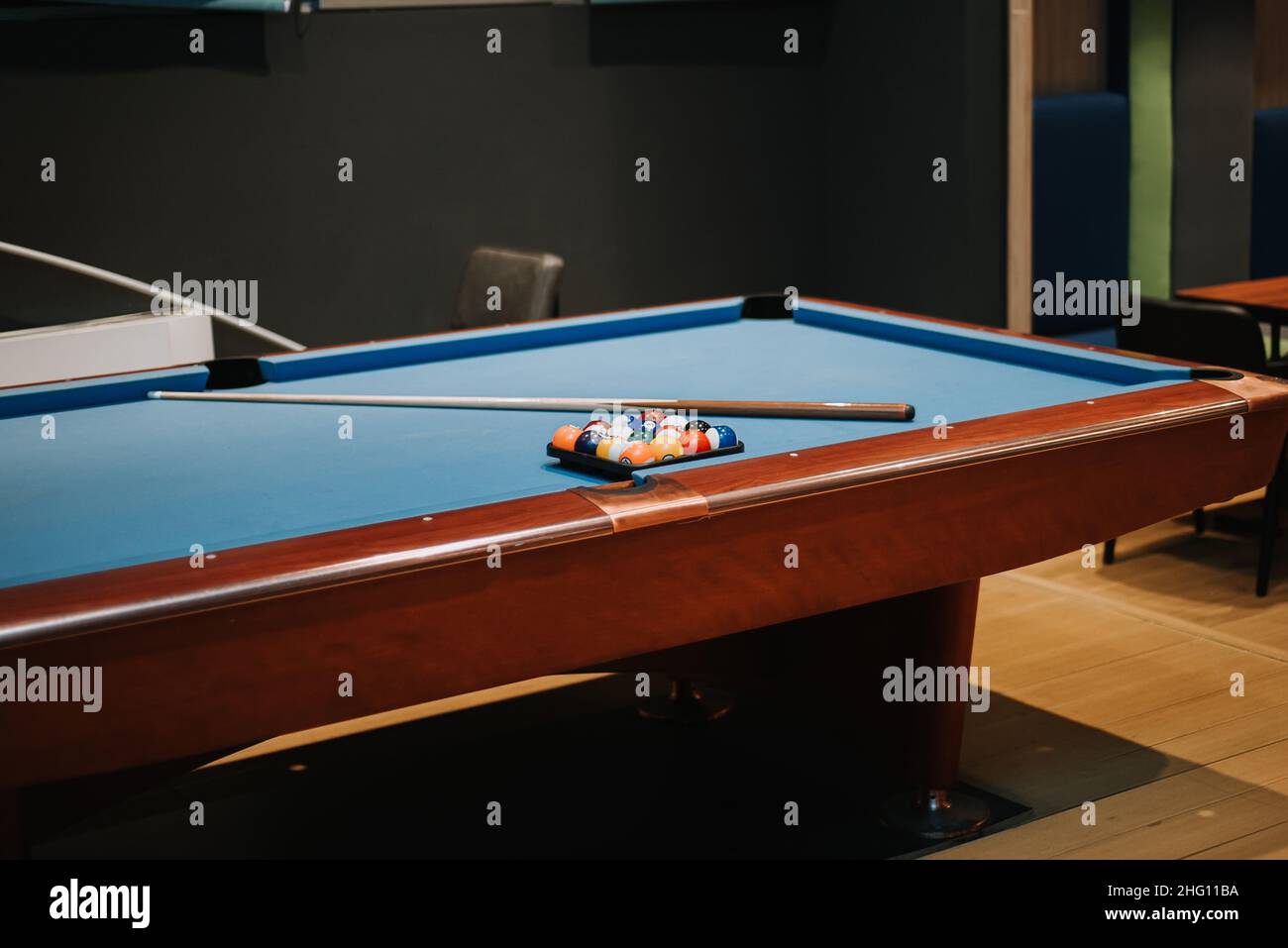 billiard pool table with stick and rack balls Stock Photo