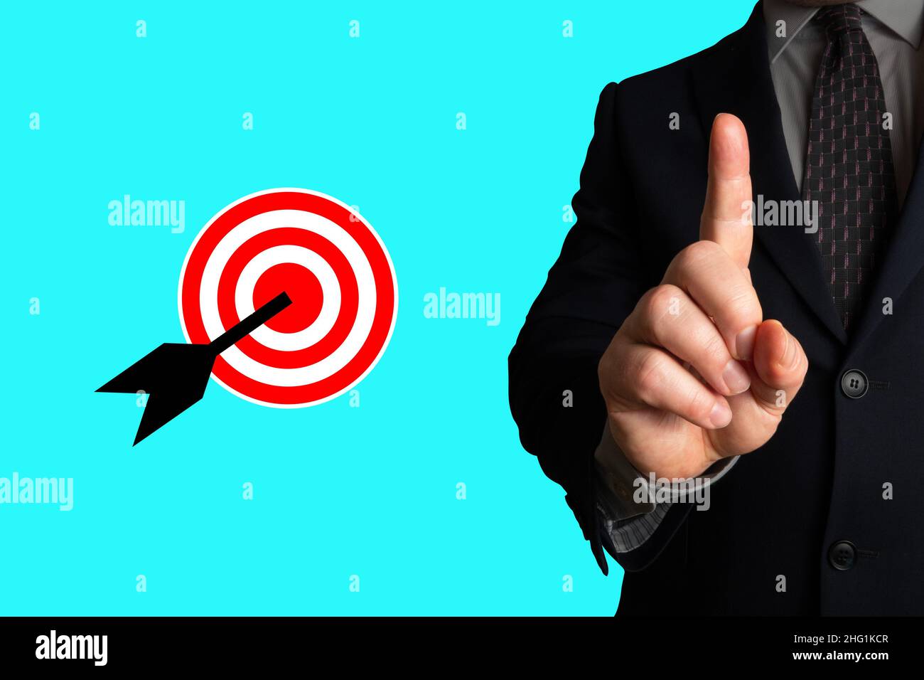 Raised finger of a businessman stressing completion or achievment or reaching of a goal, objective or target (bullseye). Symbol of success. Stock Photo