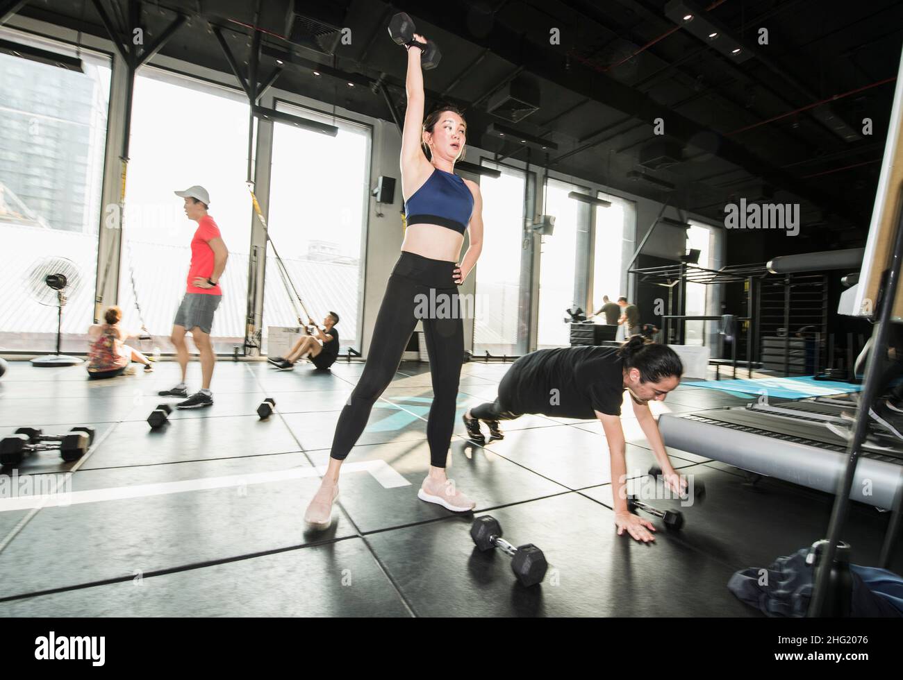 people working out during group fitness training at gym in Bangkok Stock Photo
