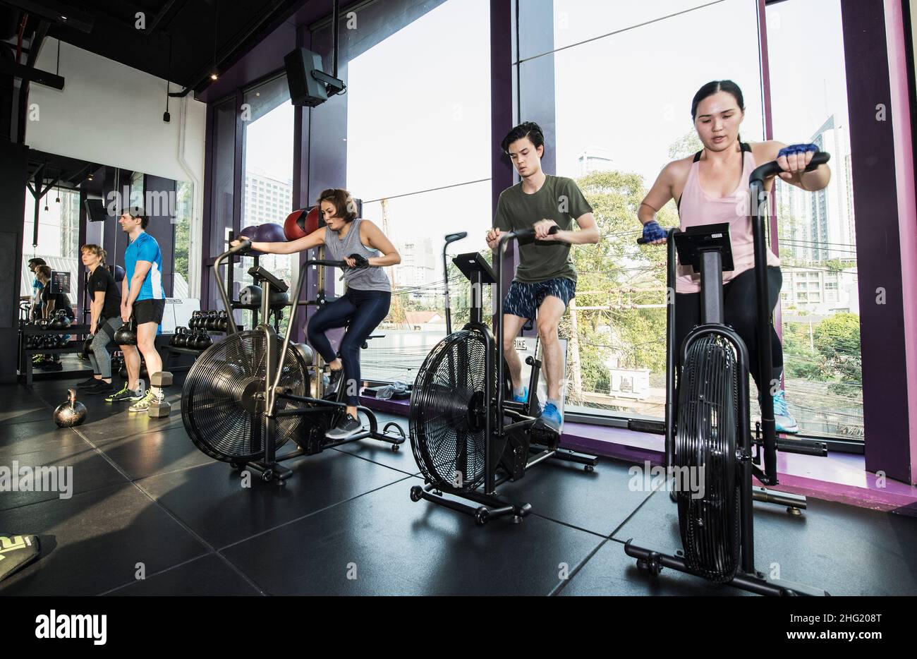 people working out during group fitness training at gym in Bangkok Stock Photo