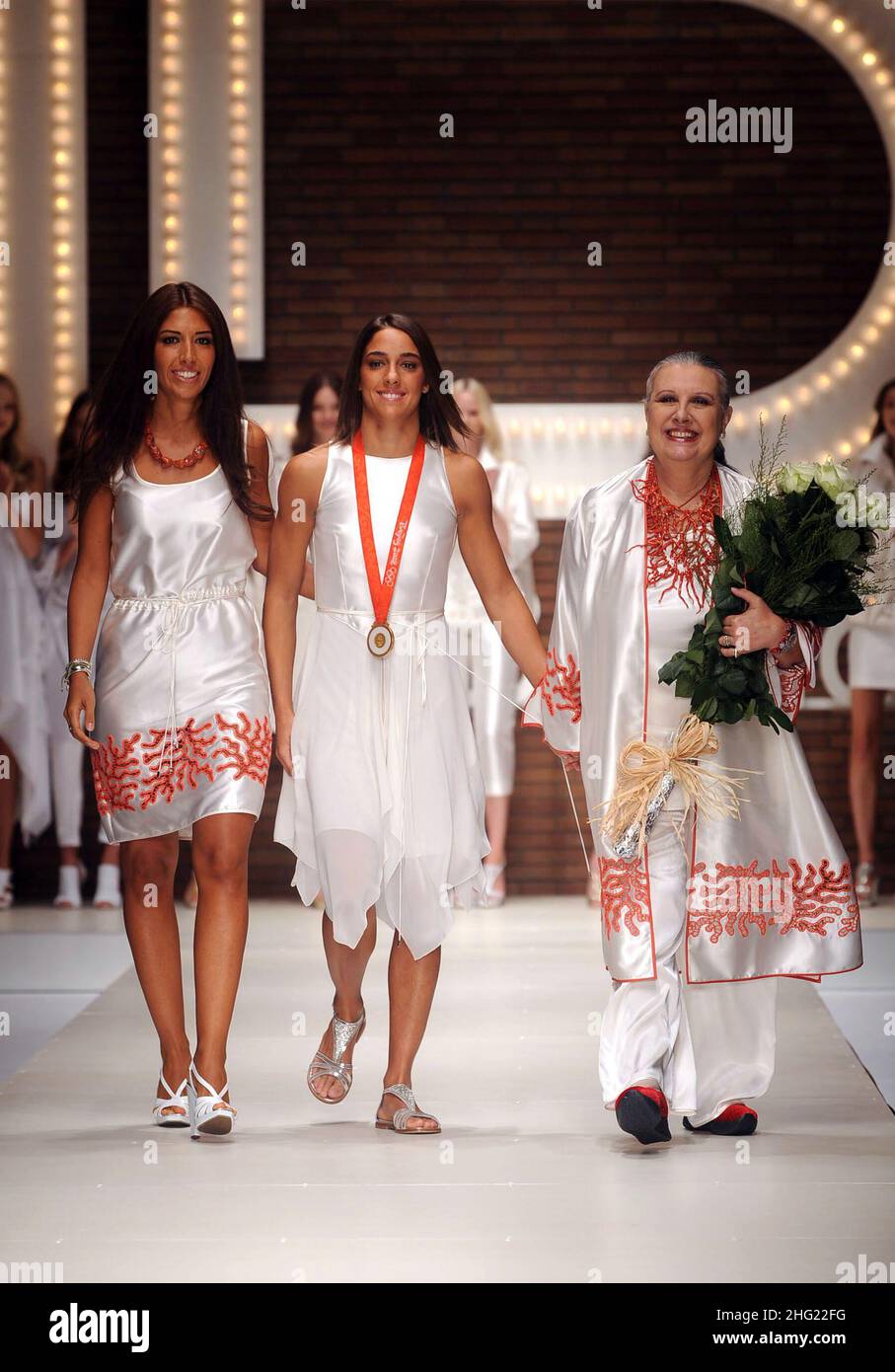 Italian judo lightweight Olympic gold medalist Giulia Quintavalle (center) with designer Laura Biagiotti (right) and her daughter Lavinia at the end of the Laura Biagiotti show during Milan Fashion Week. Stock Photo