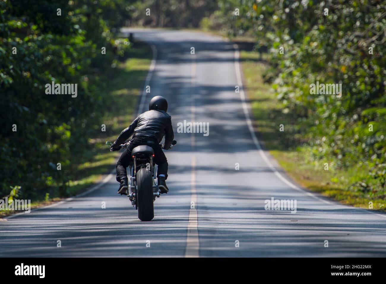 man riding an electric motorcycle in Thailand Stock Photo - Alamy