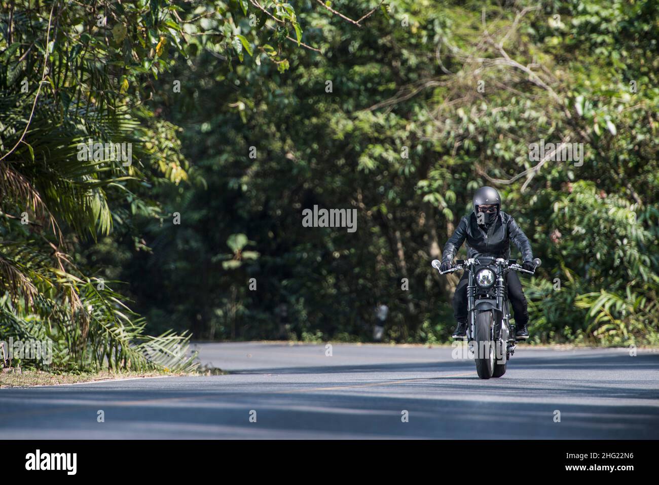 man riding an electric motorcycle in Thailand Stock Photo - Alamy