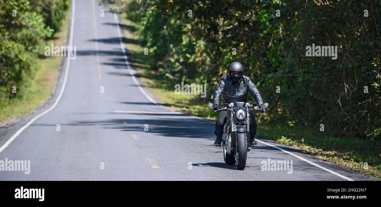 man riding an electric motorcycle in Thailand Stock Photo - Alamy