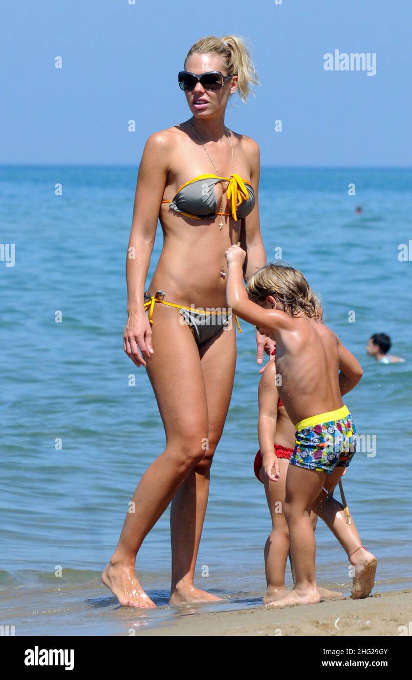 Ilary Blasi, wife of soccer player Francesco Totti, relaxing on the beach with her kids Cristian and Chanel in the coastal town Sabaudia in Lazio, Italy. Stock Photo
