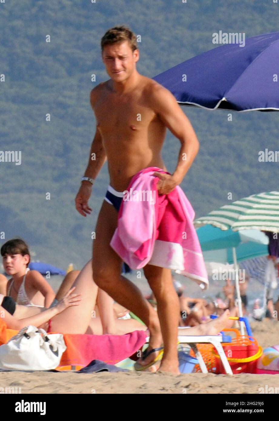 Italian soccer palyer Francesco Totti having an ice cream with friend Alessandra Pierelli on the beach in Sabaudia, Italy. Stock Photo