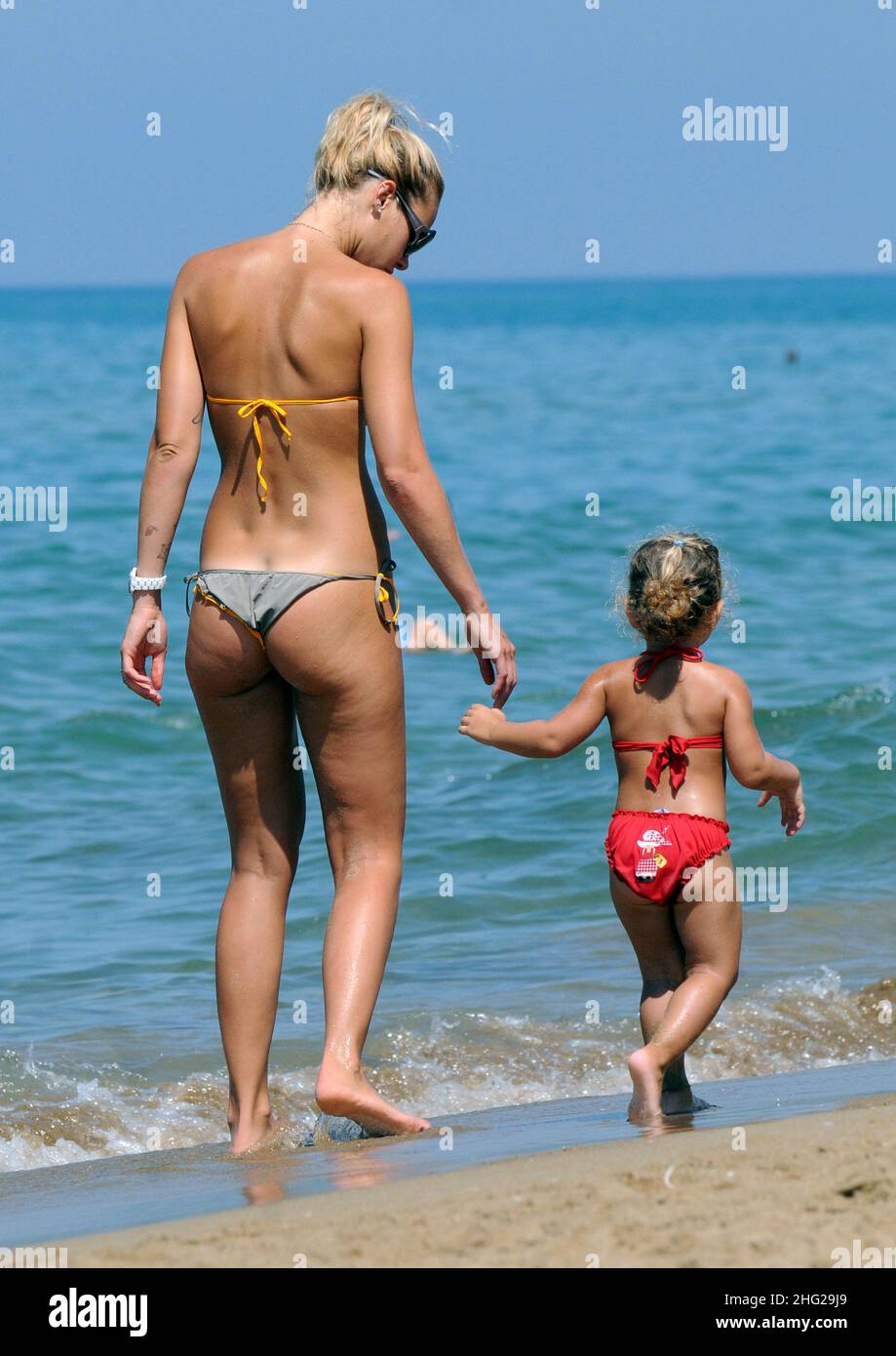 Ilary Blasi, wife of soccer player Francesco Totti, relaxing on the beach with her kids Cristian and Chanel in the coastal town Sabaudia in Lazio, Italy. Stock Photo