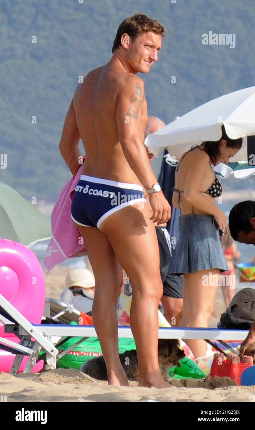 Italian soccer palyer Francesco Totti having an ice cream with friend Alessandra Pierelli on the beach in Sabaudia, Italy. Stock Photo