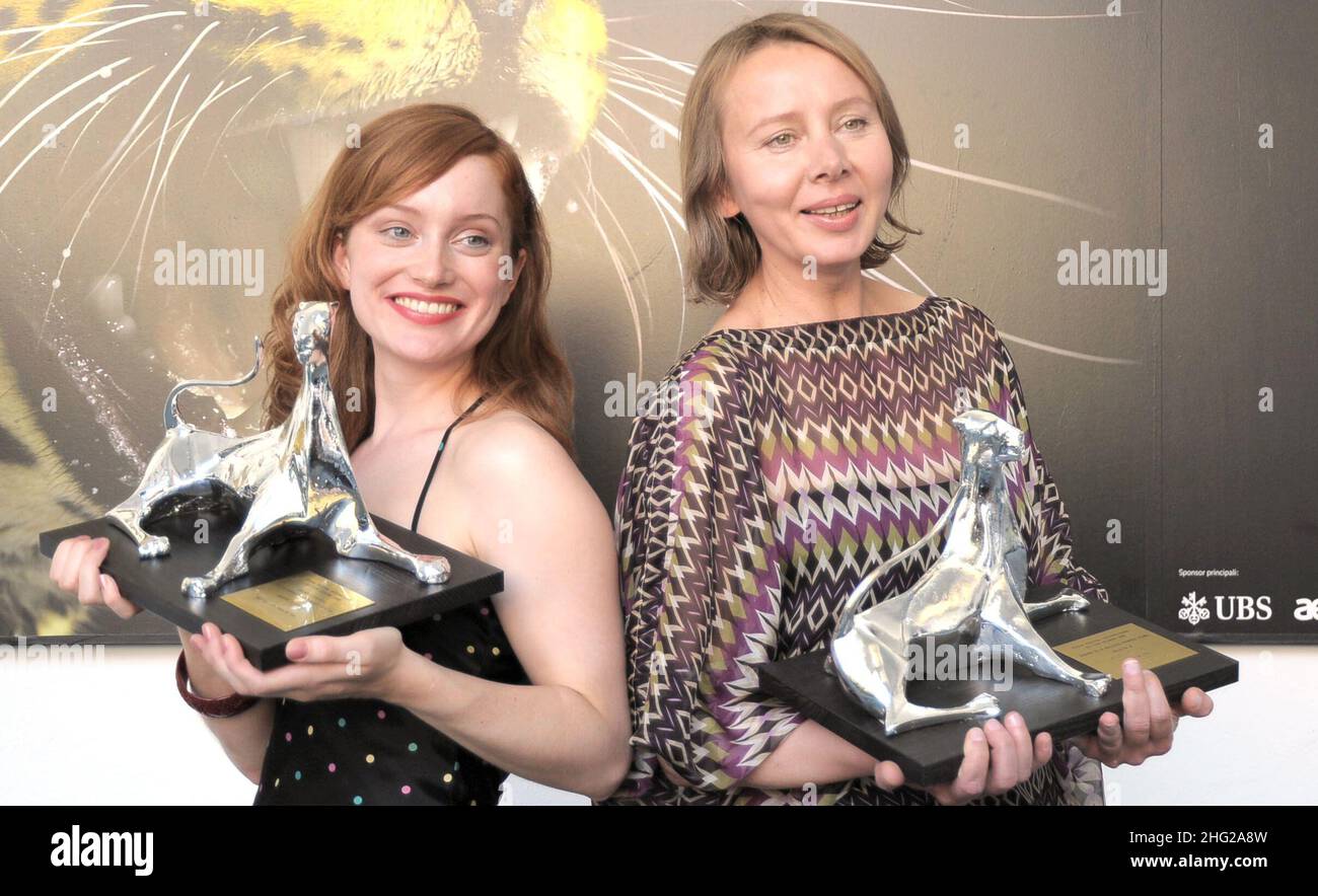 Polish-born Dutch director Urszula Antoniak, right, holds the Leopard for the best first feature of the Filmmakers of the Present Competition she received for her movie 'Nothing Personal', and Dutch actress Lotte Verbeek, left, holds the Leopard for best actress she received for her role in the movie 'Nothing Personal', during a photocall at the 62nd Locarno International Film Festival Stock Photo