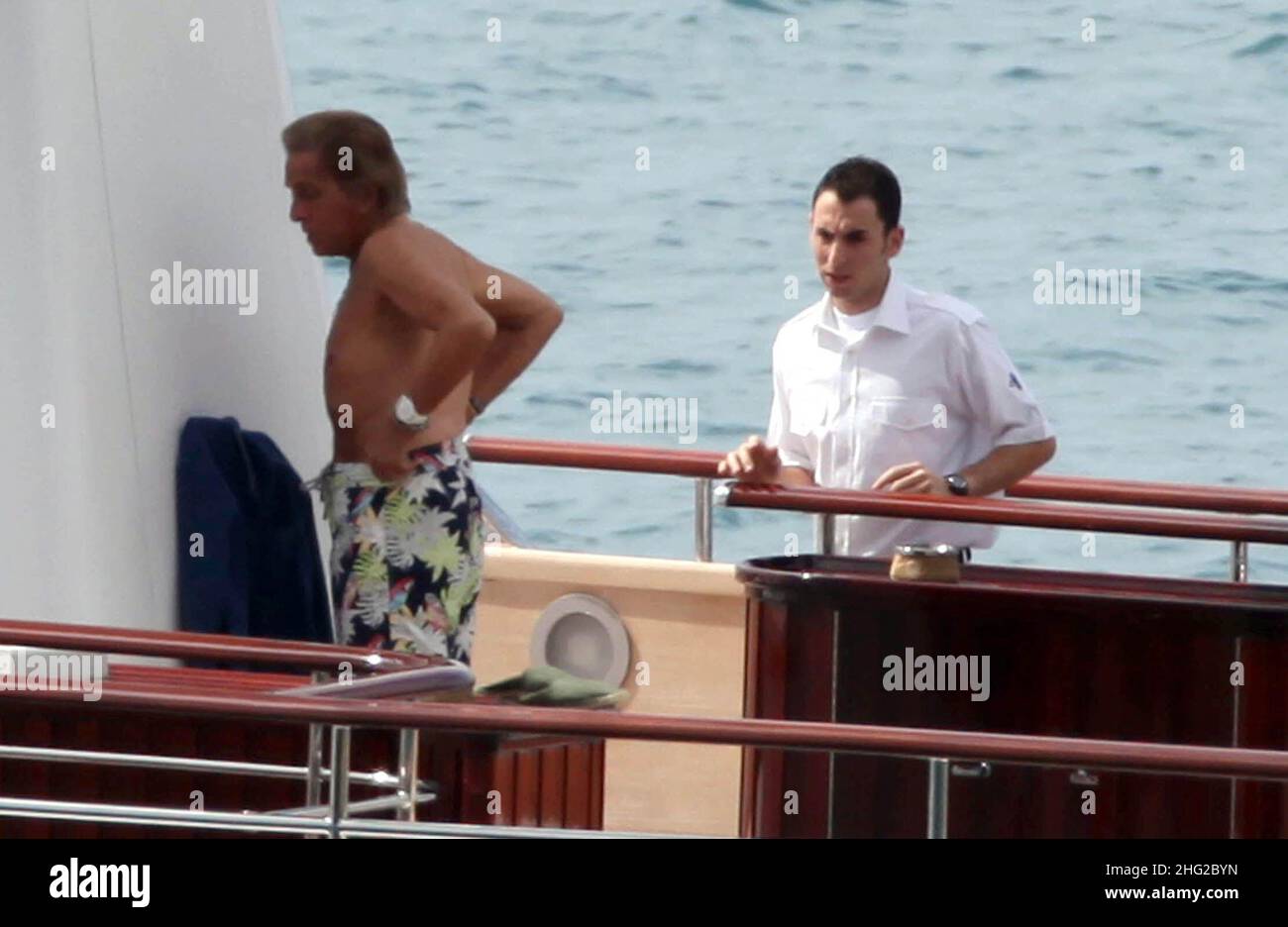 EXCLUSIVE PICTURES. Italian stylist Valentino on his yacht with a friend in Porto Santo Stefano, Tuscany, Italy. Stock Photo