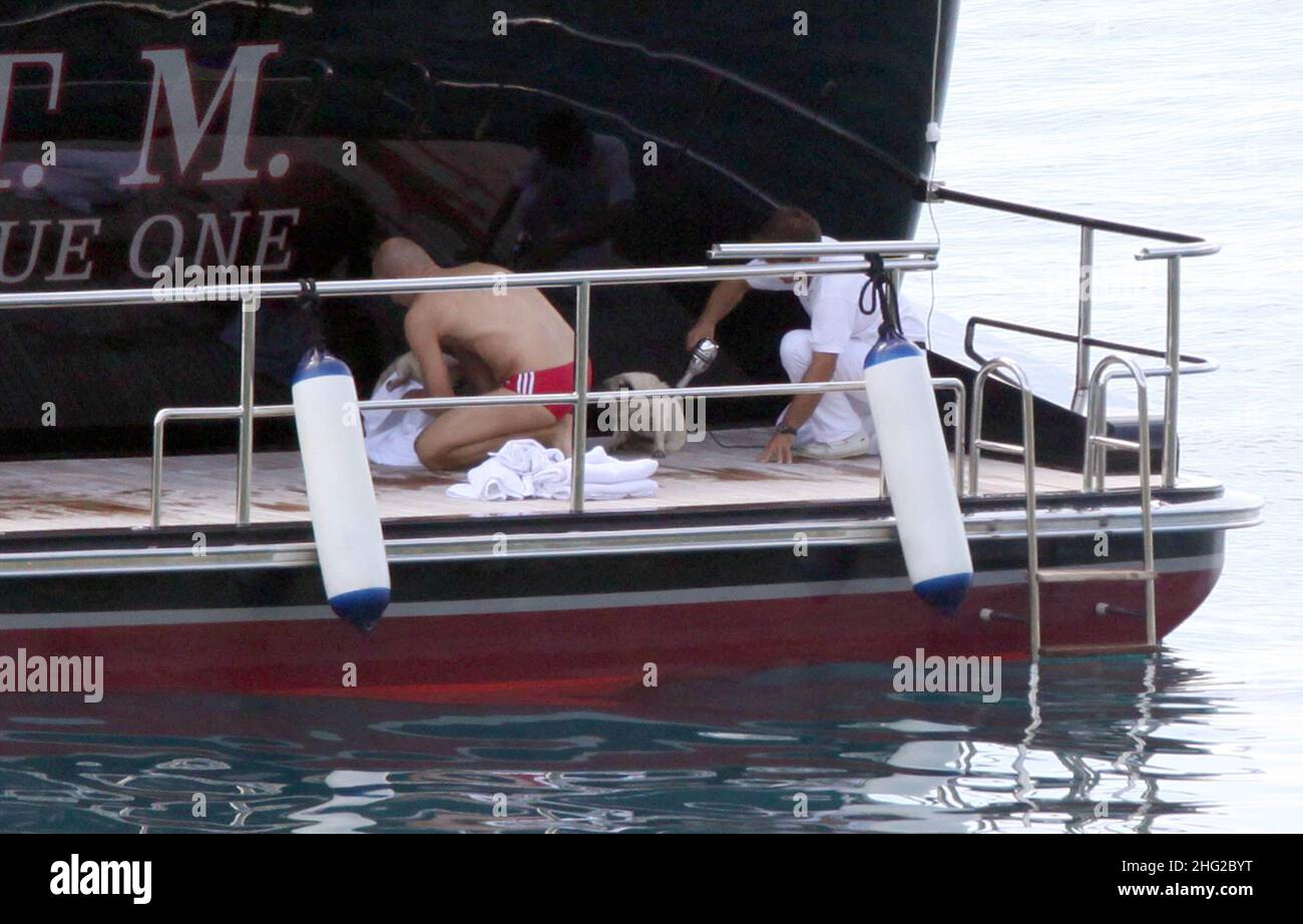 EXCLUSIVE PICTURES. Assistants pamper Italian stylist Valentino's dogs on his yacht in Porto Santo Stefano, Tuscany, Italy. Stock Photo
