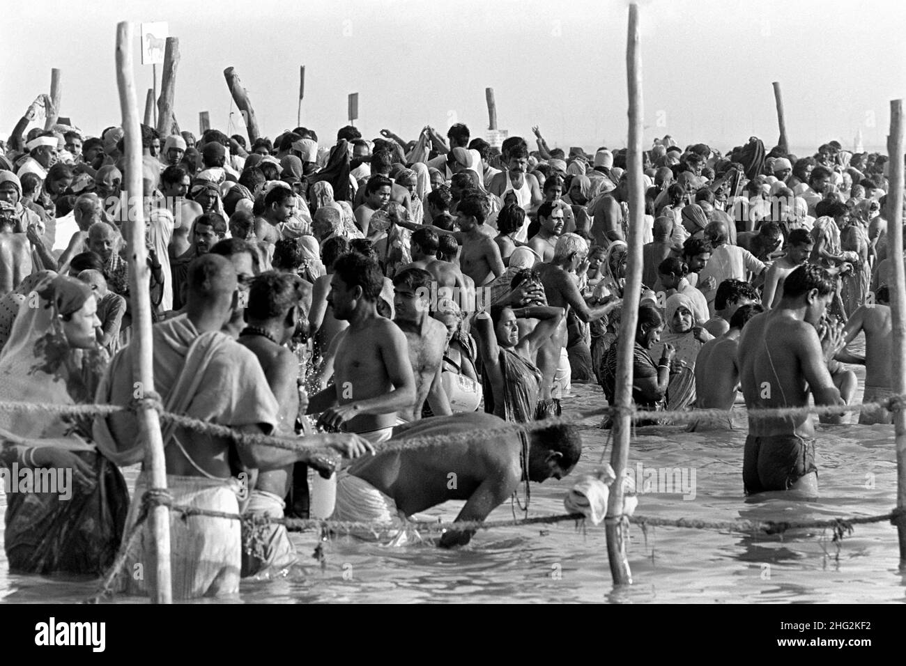 Indian pilgrims perform ritual bathing in the confluence of the Ganges and Yamuna Rivers at the climax of the Kumbh Mela festival February 6, 1989 in Allahabad, India. The six-week festival is held every 12th year and attracts millions of Hindu pilgrims. Stock Photo