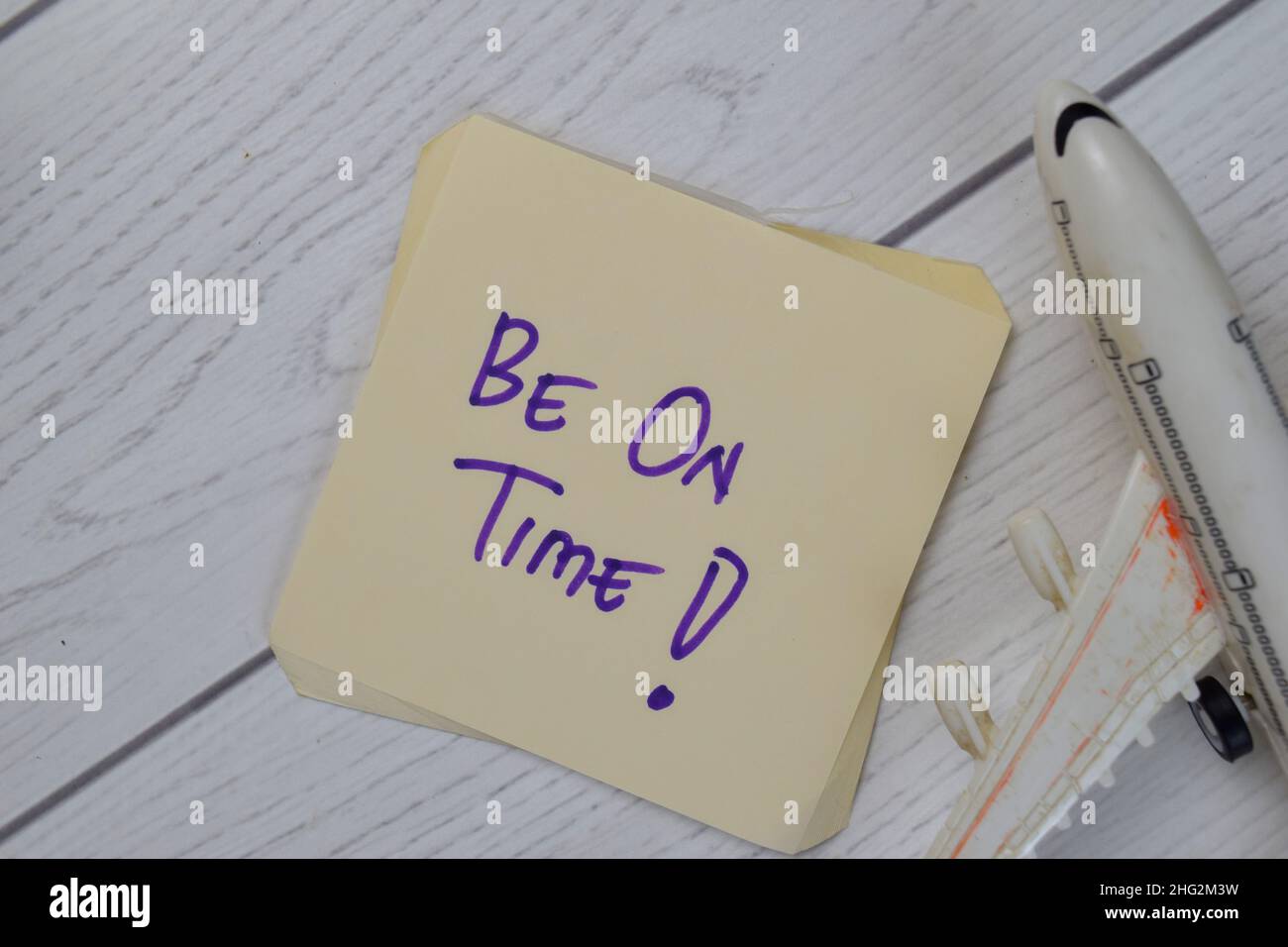 Be On Time write on sticky notes isolated on Wooden Table. Stock Photo