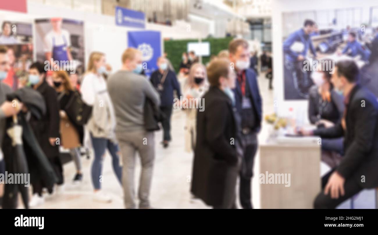 Abstract blured people at exhibition hall of expo event trade show. Business convention show or job fair. Business concept background. Stock Photo