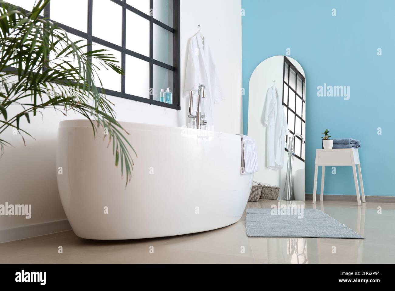 Interior of stylish bathroom with modern bathtub and mirror Stock Photo