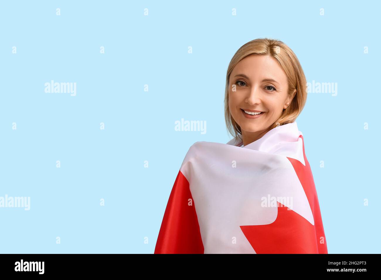 Mature woman with Canadian flag on color background Stock Photo - Alamy