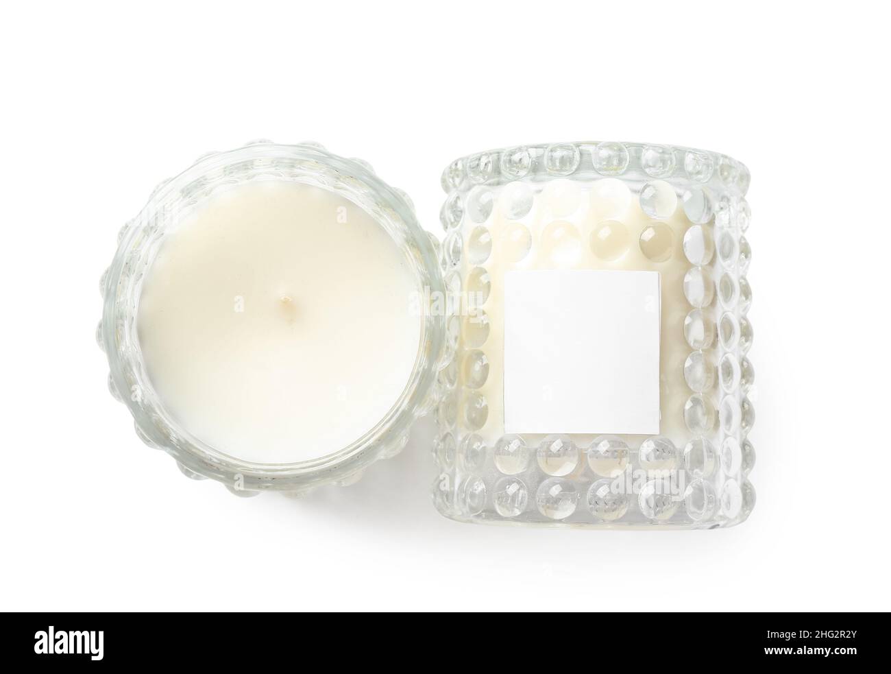Beautiful wax candles in glass holders isolated on white background ...