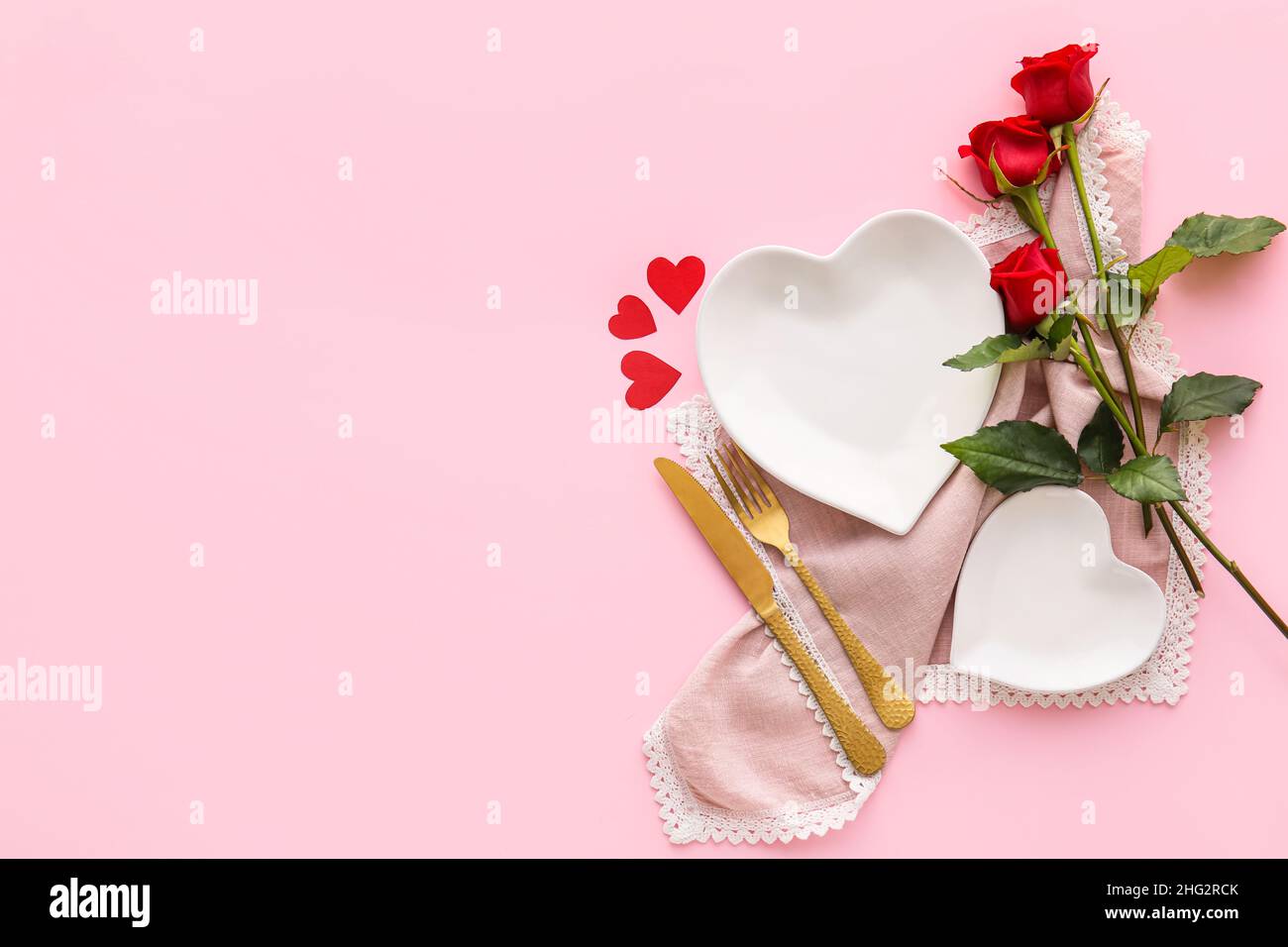 Beautiful table setting for Valentine's Day and rose flowers on pink ...