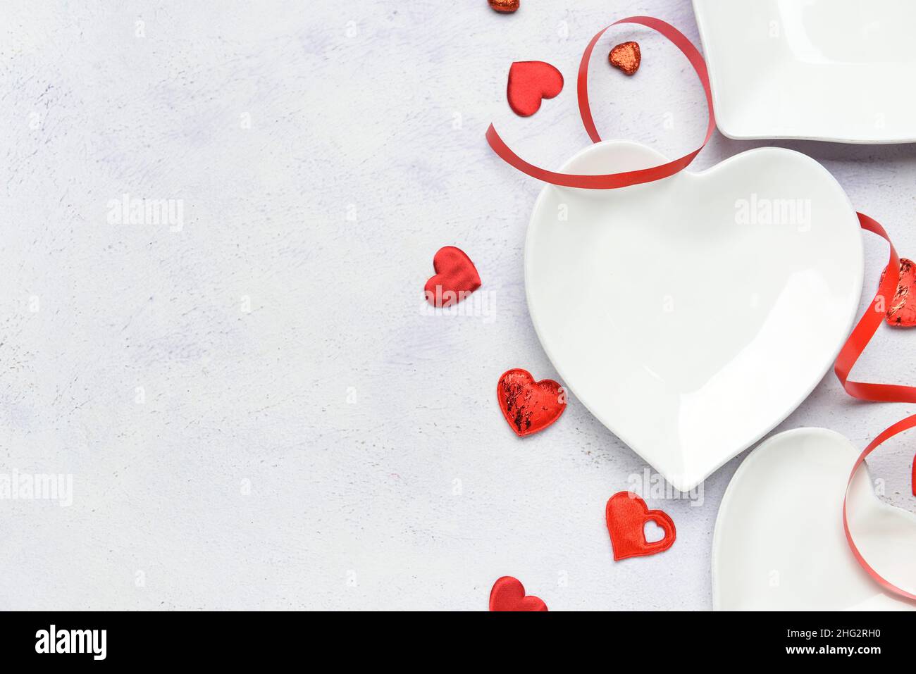 Beautiful heart shaped plates on white background Stock Photo - Alamy