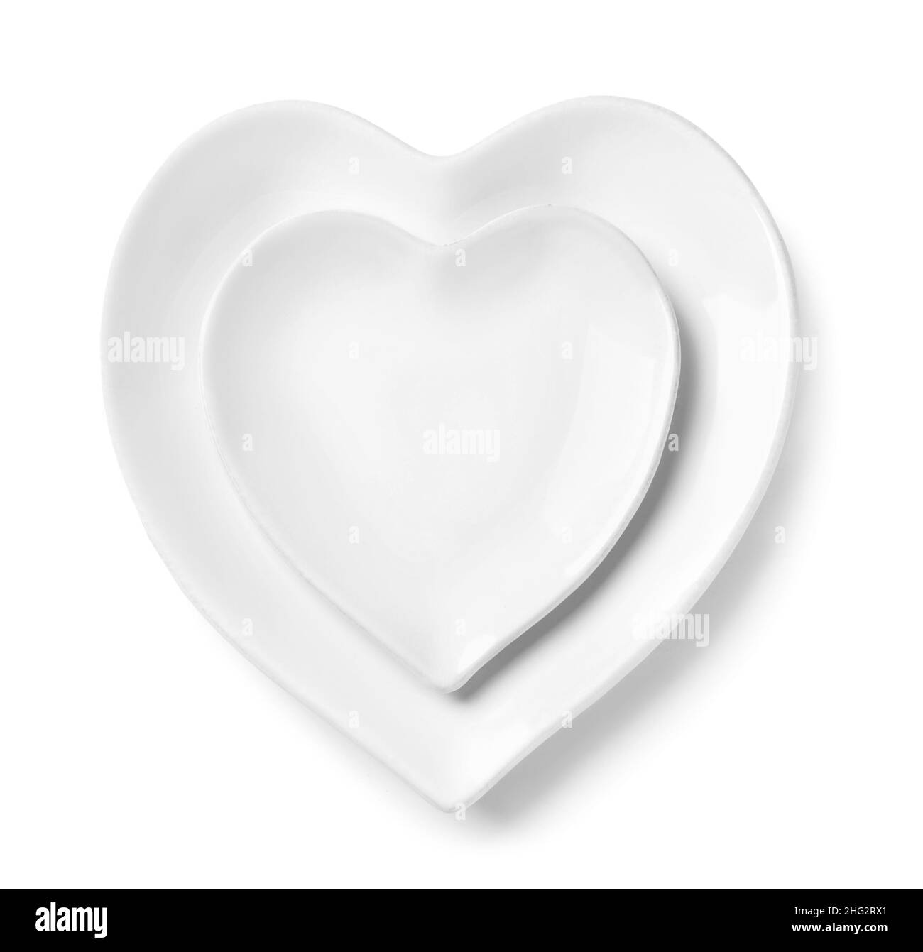 Beautiful heart-shaped plates on white background Stock Photo - Alamy