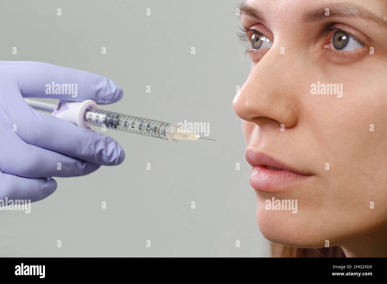 Lips augmentation injections for attractive woman. Plastic surgeon does