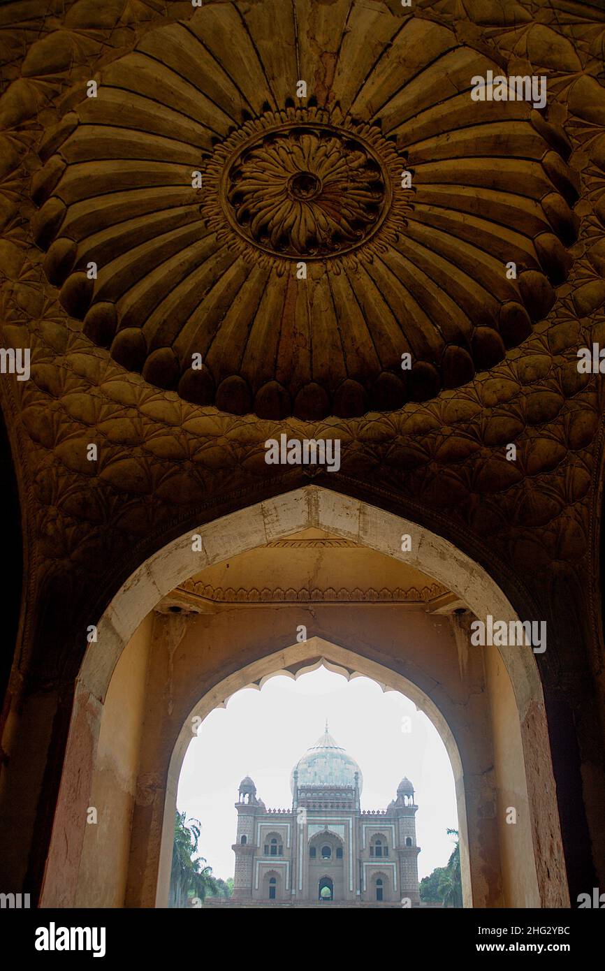 View of Safdarjung Tomb through entrance gate in foreground, Delhi Stock Photo