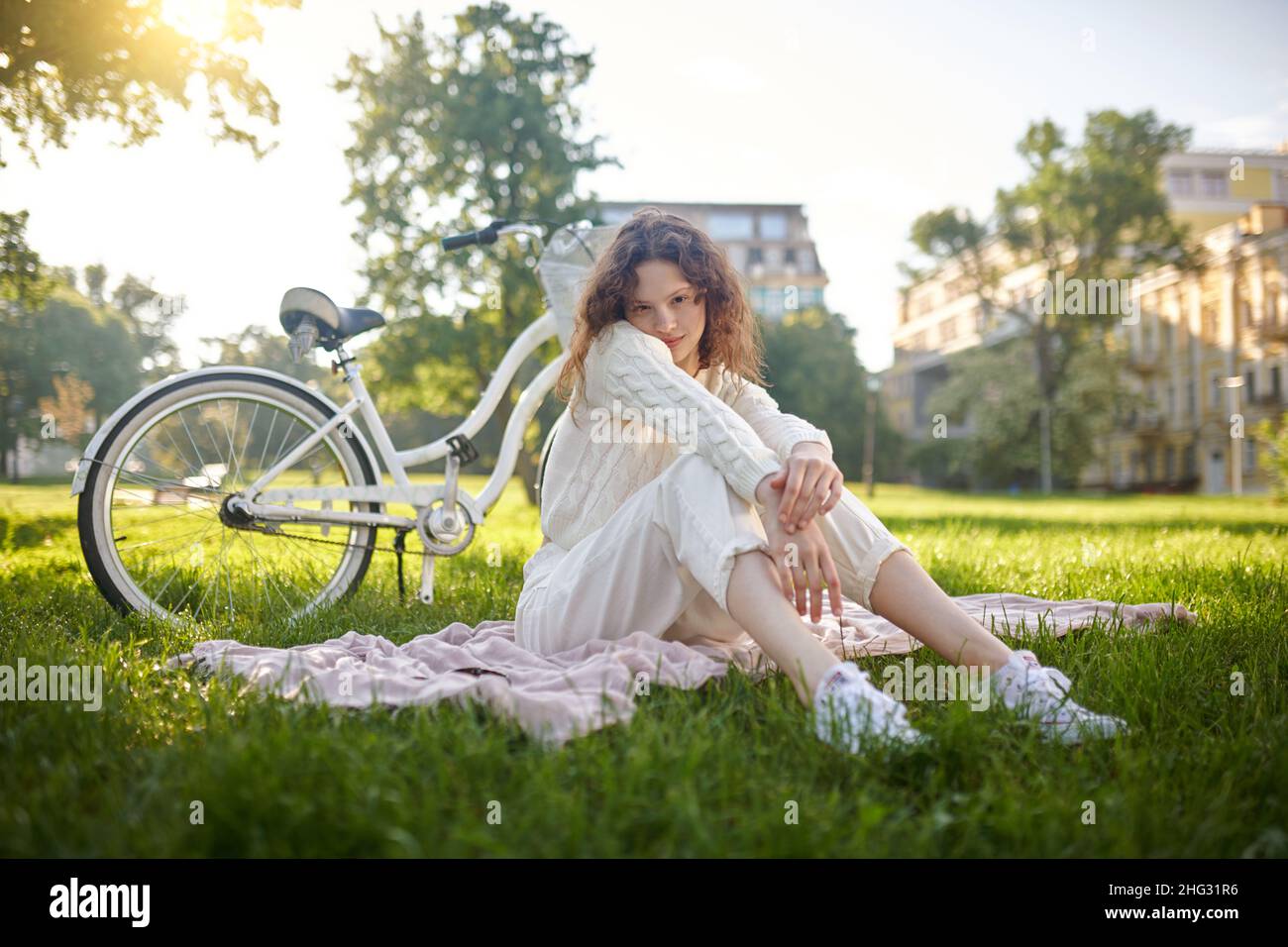 Relaxed young girl on the grass in the park Stock Photo - Alamy