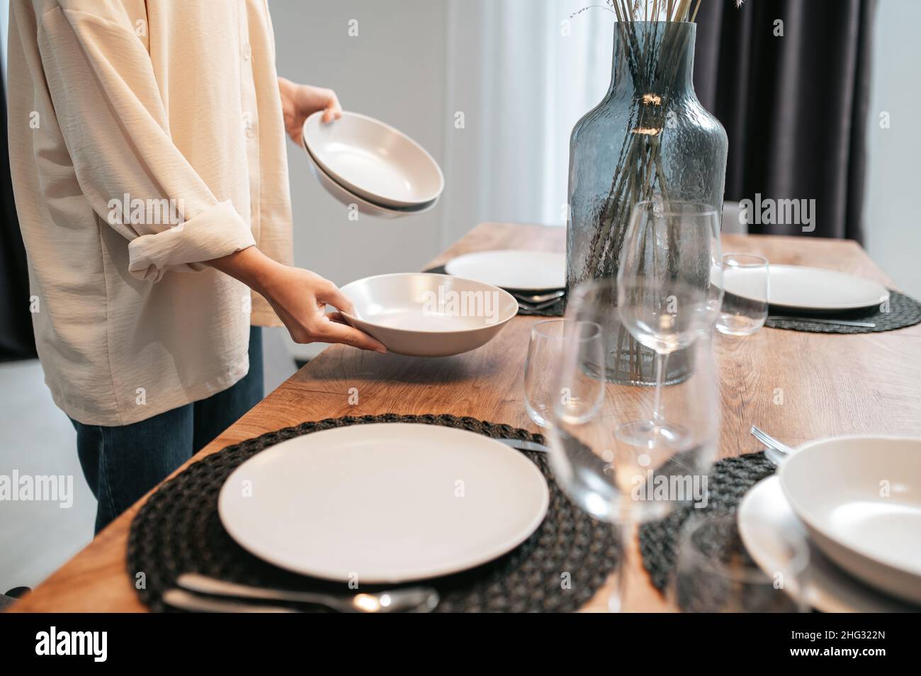 Put the plates the table. Put the plates the table